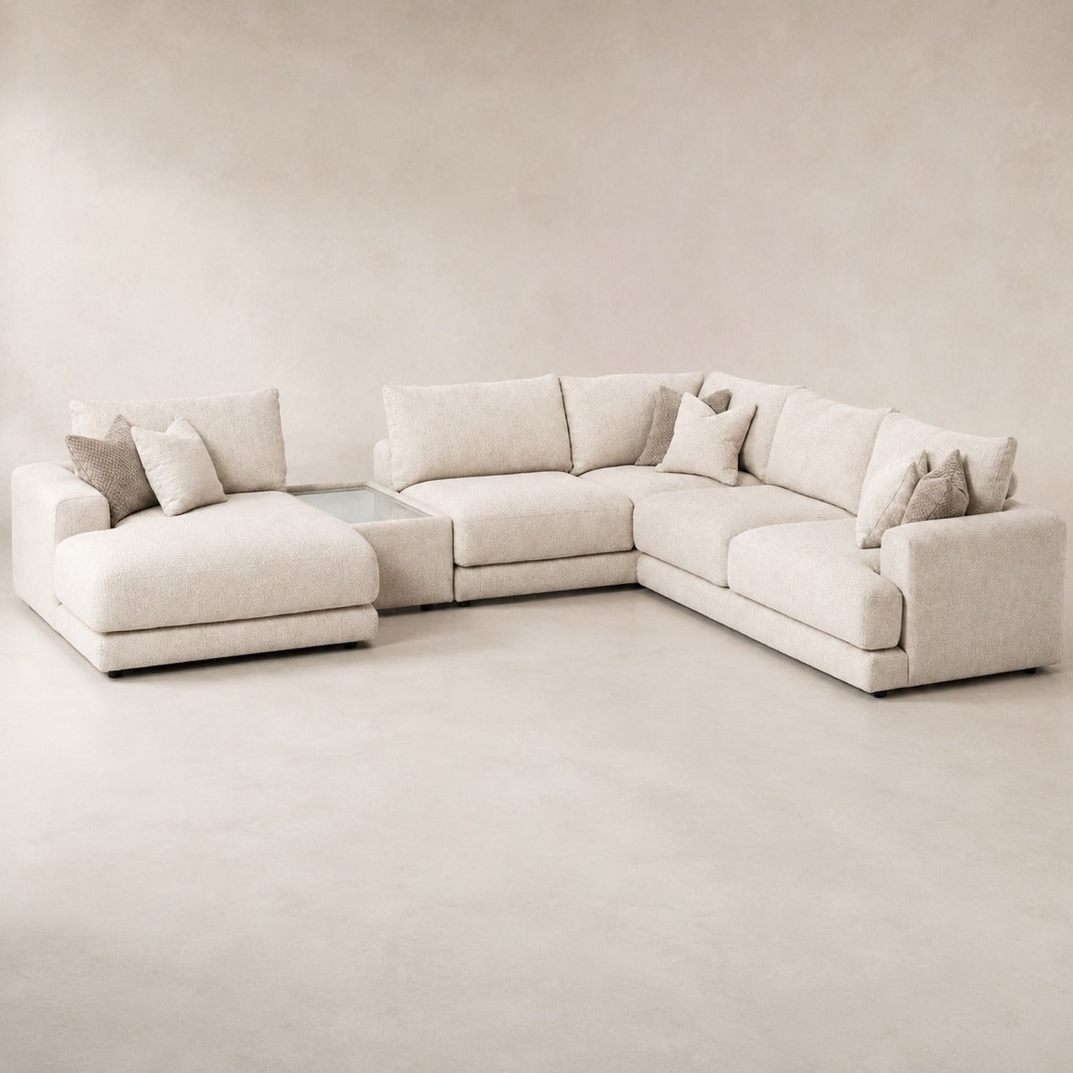 Aurelia Large Chaise Sofa & Glass-Top Table Set in Summer Beach on a clean stone studio background