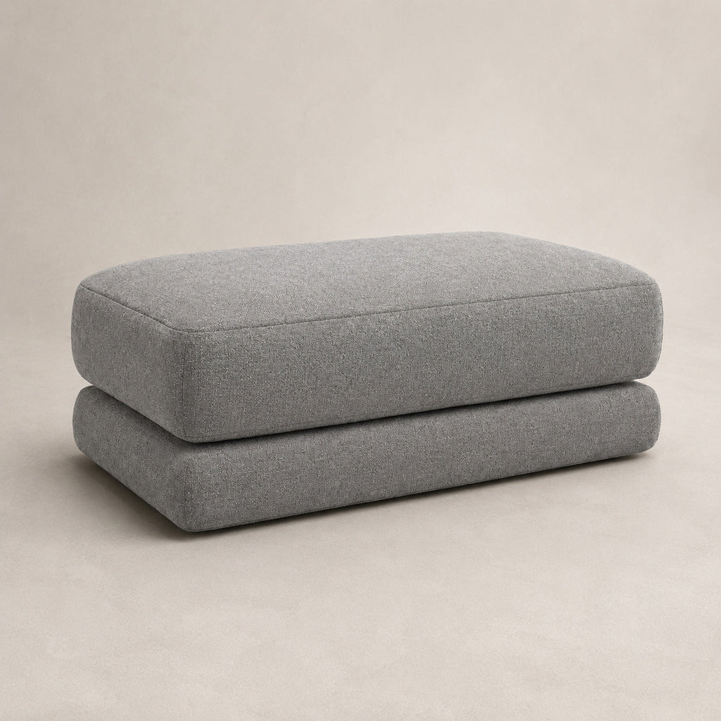 Aurelia Large Footstool in Luxe Steel Grey on a clean stone studio background