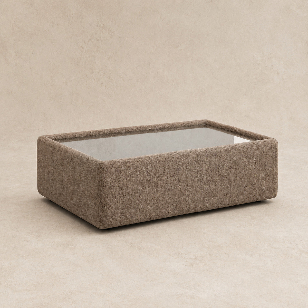 Aurelia Upholstered Rectangle Glass-Top Table in Coffee on a clean stone studio background