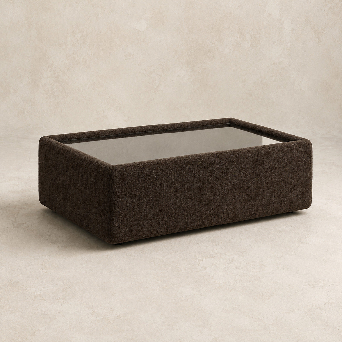 Aurelia Upholstered Rectangle Glass-Top Table in Double Espresso on a clean stone studio background