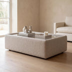 Aurelia Upholstered Rectangle Glass-Top Table styled in a realistic premium living space