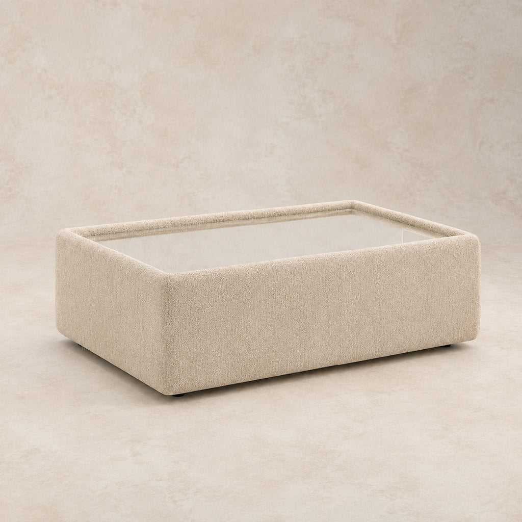 Aurelia Upholstered Rectangle Glass-Top Table in Summer Beach on a clean stone studio background