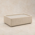 Aurelia Upholstered Rectangle Glass-Top Table in Summer Beach on a clean stone studio background