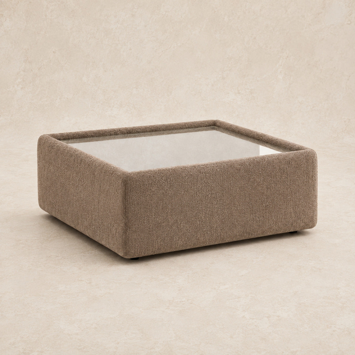 Aurelia Upholstered Square Glass-Top Table in Coffee on a clean stone studio background