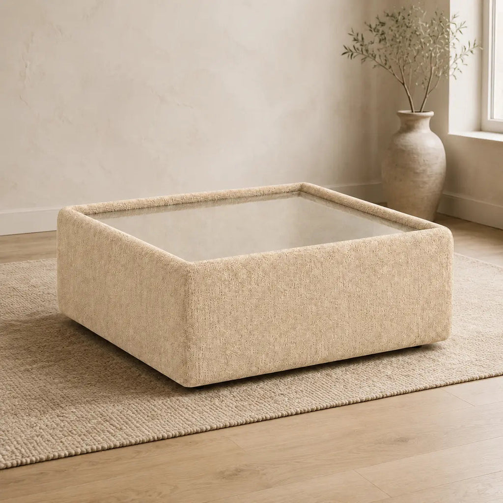 Aurelia Upholstered Square Glass-Top Table styled in a realistic premium living space