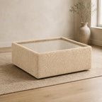 Aurelia Upholstered Square Glass-Top Table styled in a realistic premium living space
