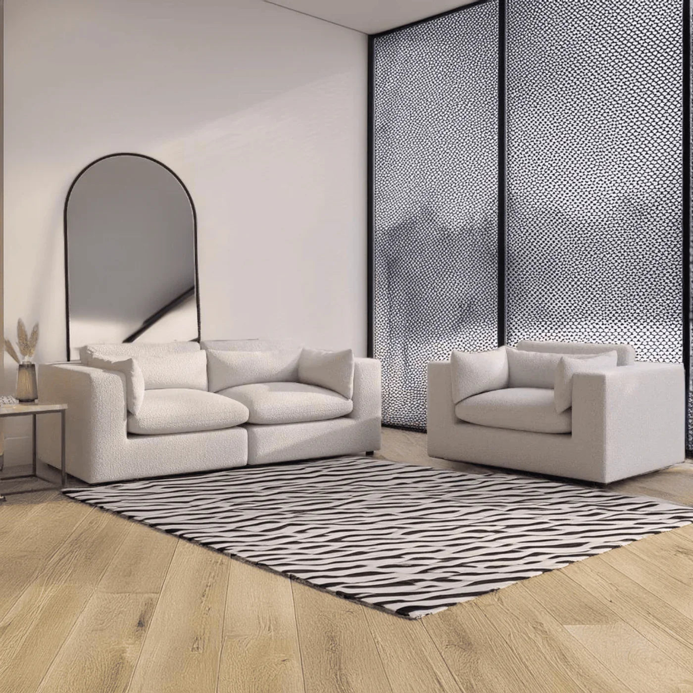 Modern white textured sofa and armchair set in minimalist living room with zebra rug and arched mirror