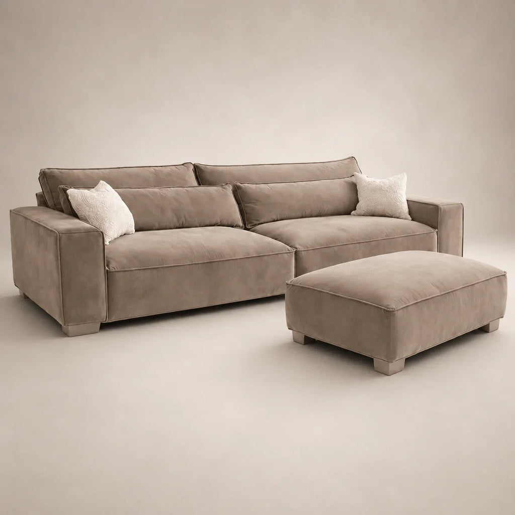 Luxury beige sectional sofa with matching ottoman and white accent pillows, ideal for modern living rooms.