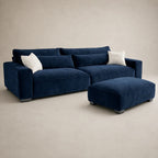 Luxury navy velvet sectional sofa with matching ottoman and white pillows, modern living room furniture