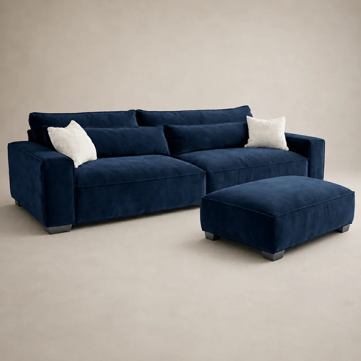 Luxury navy velvet sectional sofa with matching ottoman and white pillows, modern living room furniture