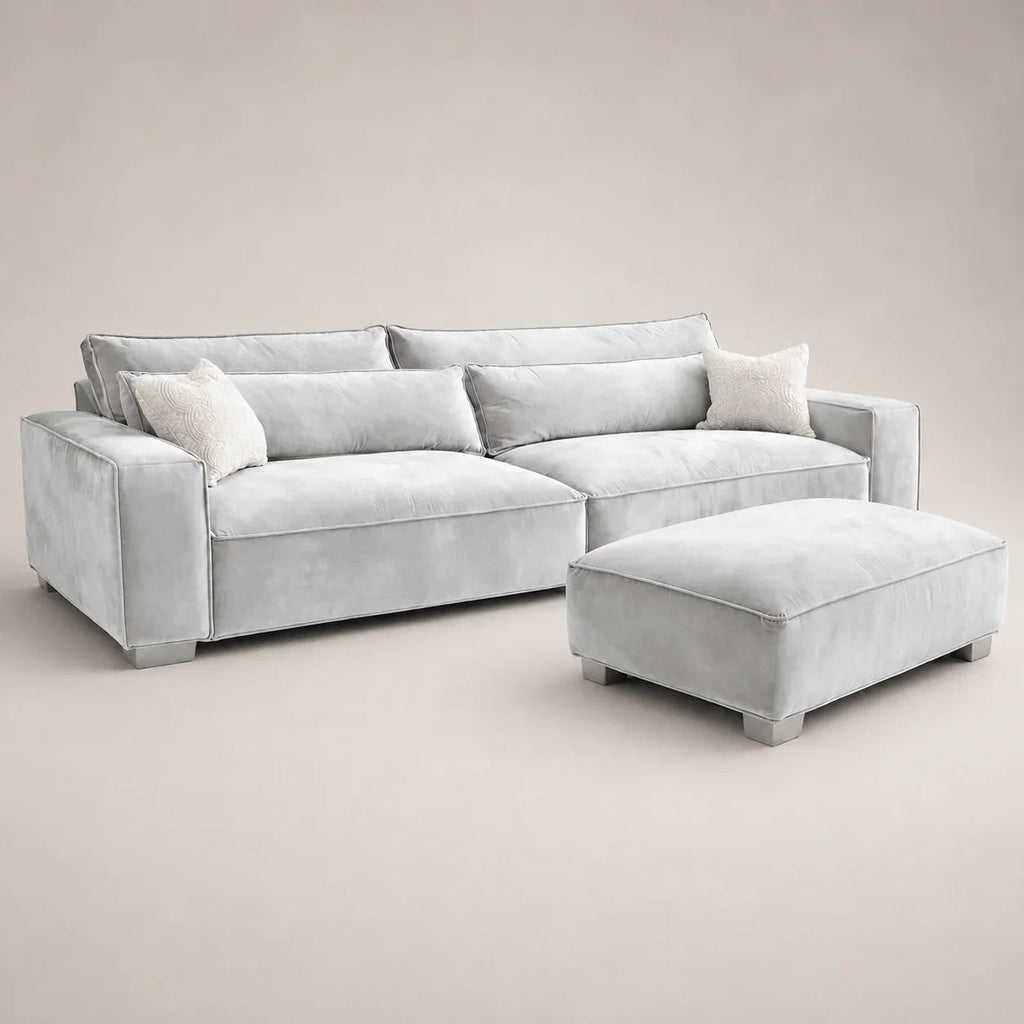 Luxury grey velvet sectional sofa with matching ottoman and decorative pillows for modern living rooms