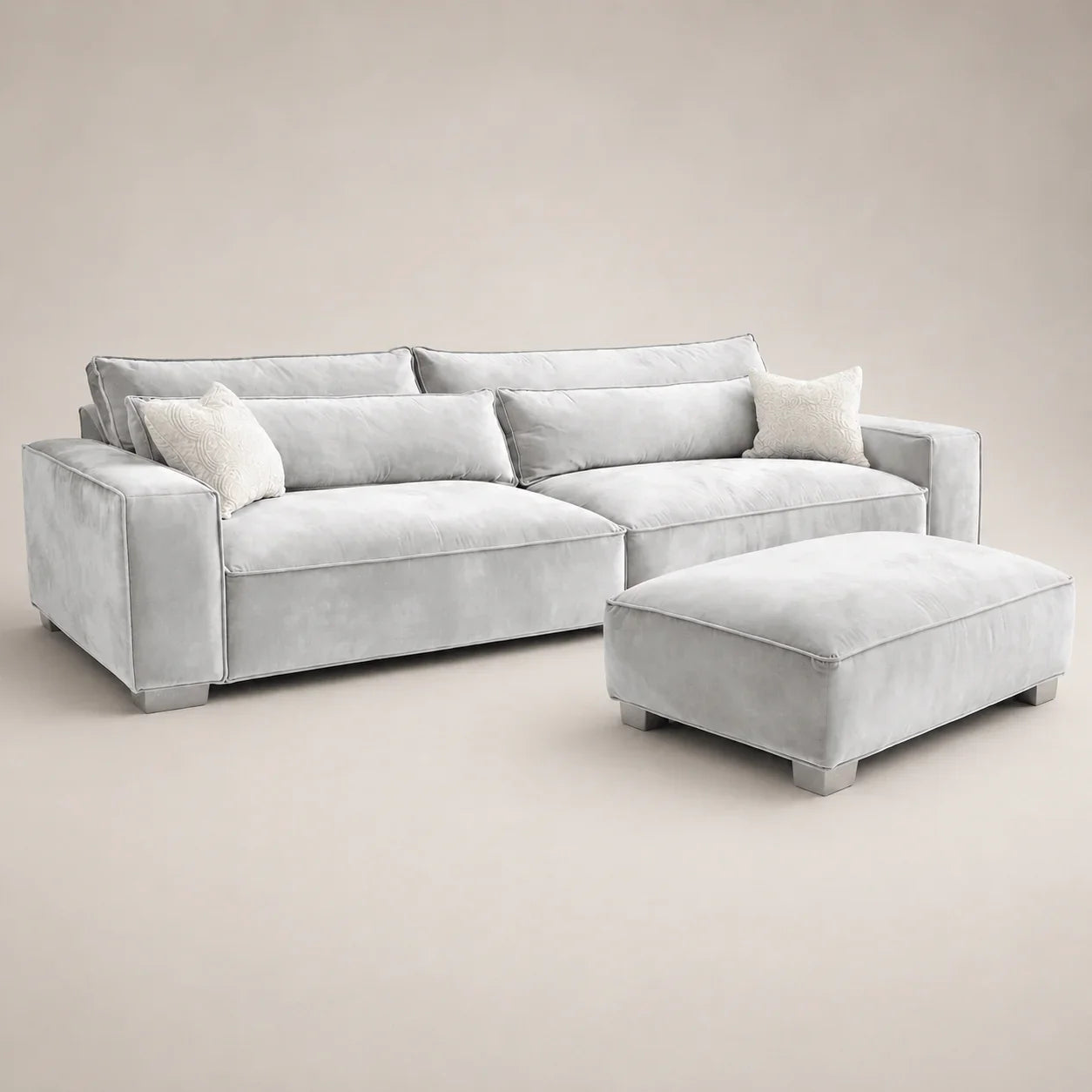 Luxury grey velvet sectional sofa with matching ottoman and decorative pillows for modern living rooms
