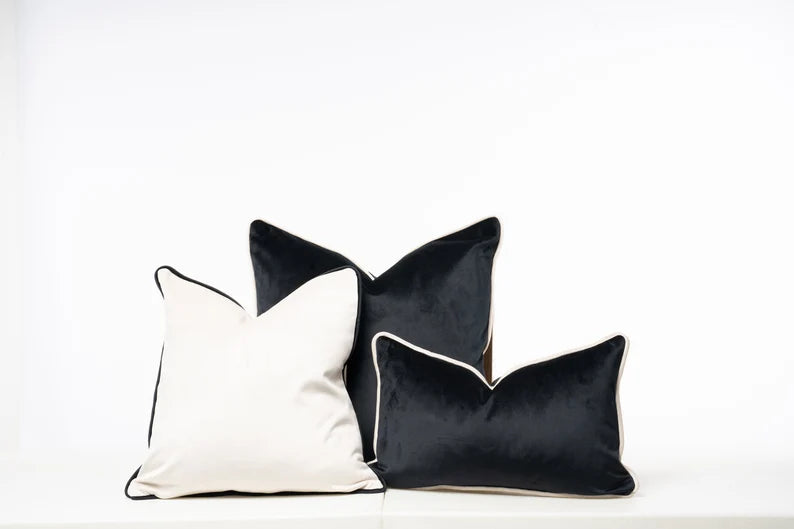 Luxury black and white velvet throw pillows with contrast piping for modern sofas and beds