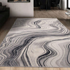 Gray and white abstract wave pattern area rug in modern living room with wooden floors