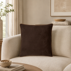 Luxury brown velvet cushion on cream sofa, modern living room decor with natural light