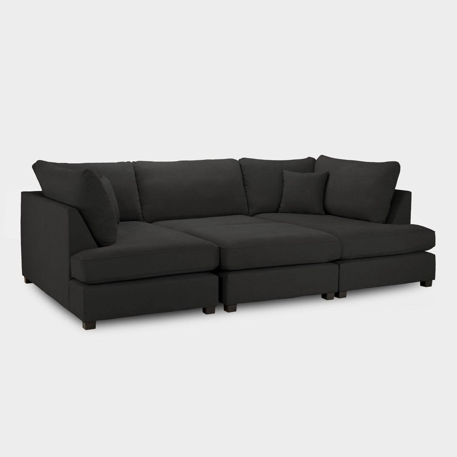Modern black U-shaped corner sofa with plush cushions on a white background