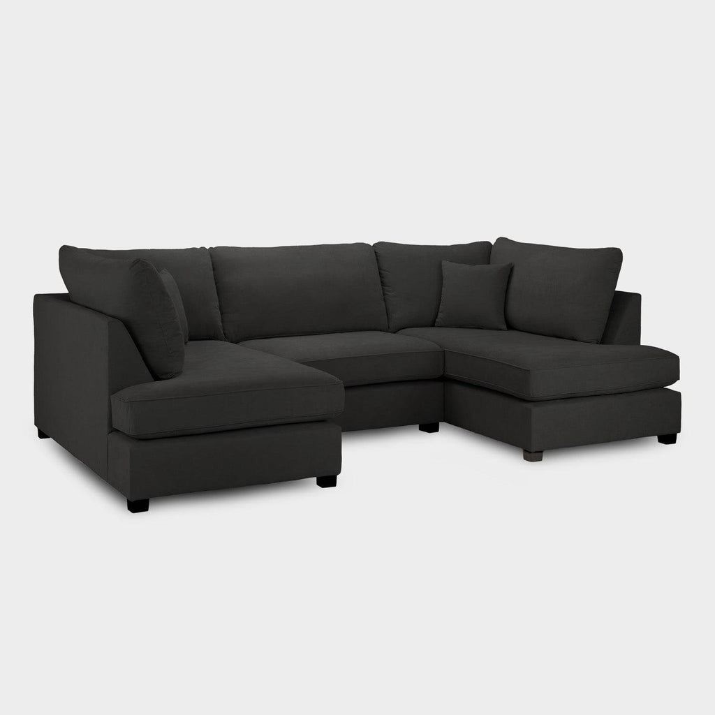 Modern black U-shaped corner sofa with plush cushions on a white background