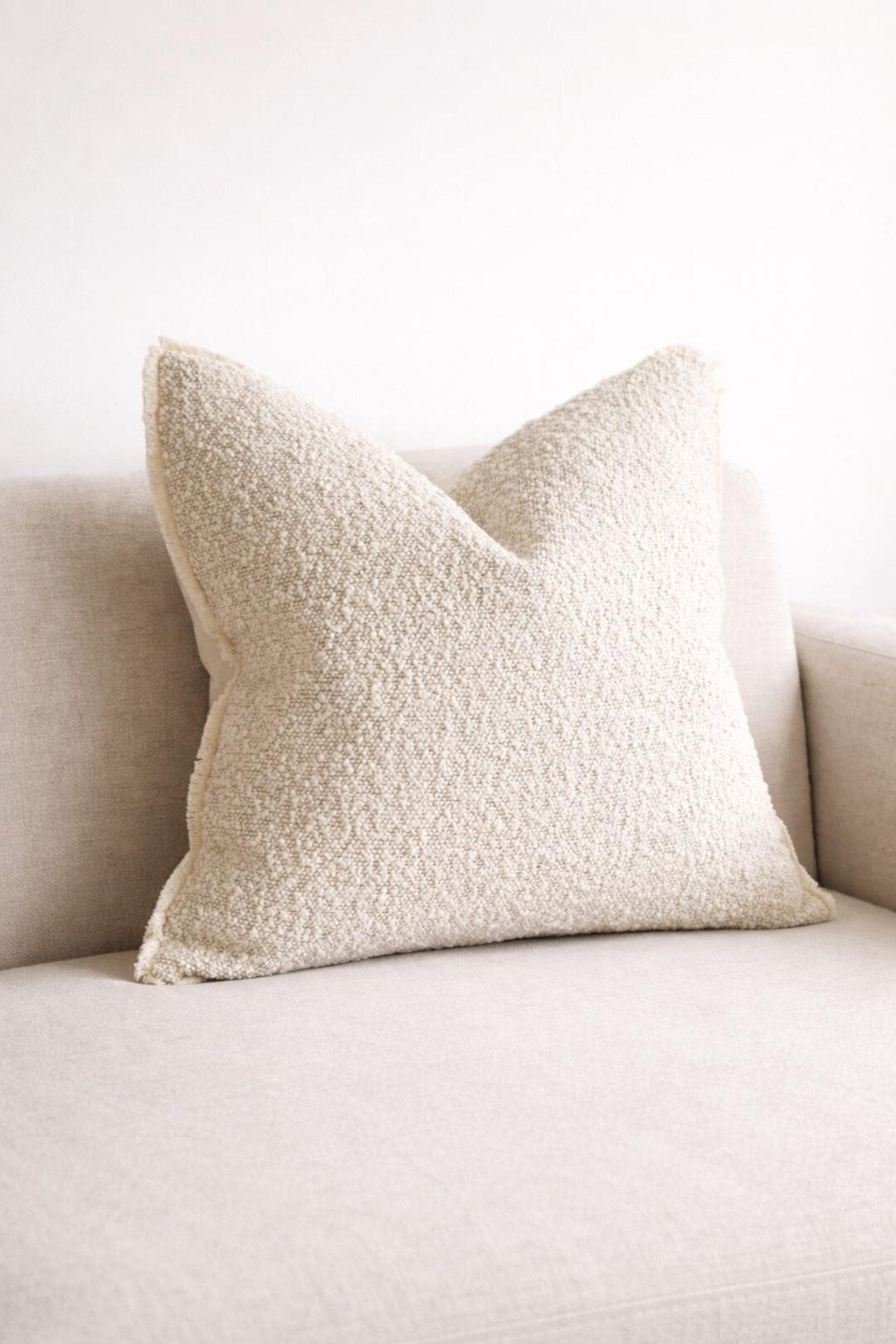 Cream textured throw pillow on neutral sofa, luxury living room decor