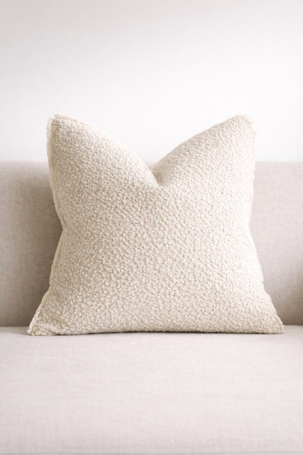 Cream textured throw pillow on neutral sofa, luxury home decor accent