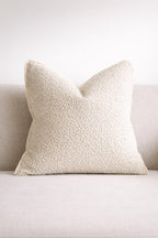 Cream textured throw pillow on neutral sofa, luxury home decor accent