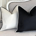 Luxury black and white velvet throw pillows on a grey sofa with nailhead trim