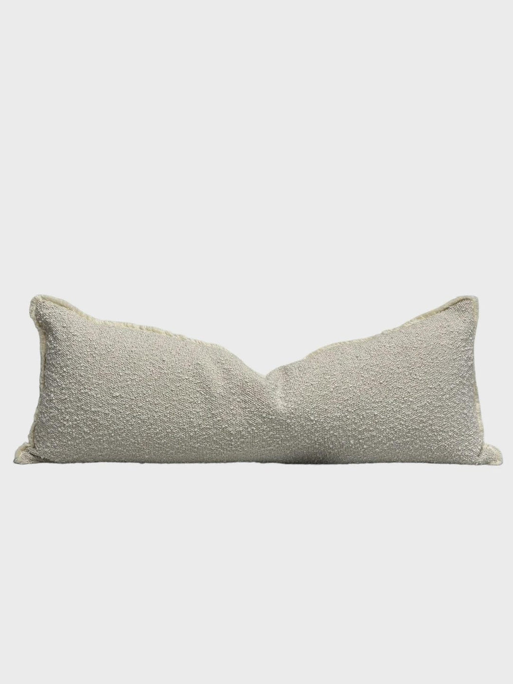 Textured beige lumbar pillow with frayed edges for luxury sofa or bed styling