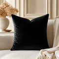 Black velvet throw pillow on beige sofa with dried hydrangeas, luxury home decor