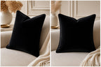 Luxury black velvet cushion on cream sofa, elegant home decor accent