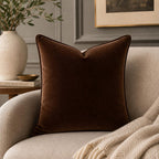 Luxury brown velvet cushion on beige sofa with cozy throw, styled living room decor