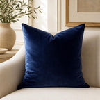 Navy blue velvet throw pillow on beige sofa, luxury home decor accent