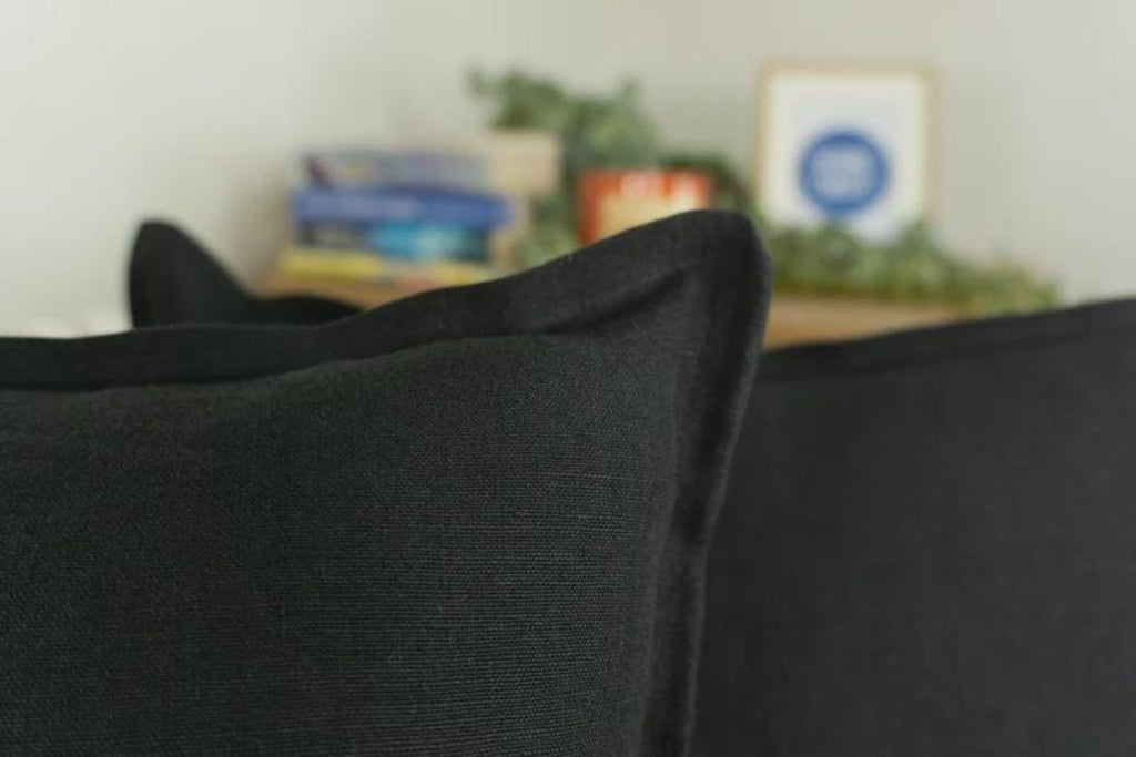 Black textured sofa cushions in modern living room setting