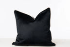 Luxury black velvet cushion with cream piping, perfect for modern sofas and beds