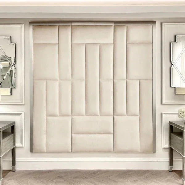Cream and silver abstract upholstered headboard with geometric panels in a luxury bedroom setting