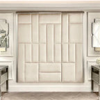 Cream and silver abstract upholstered headboard with geometric panels in a luxury bedroom setting