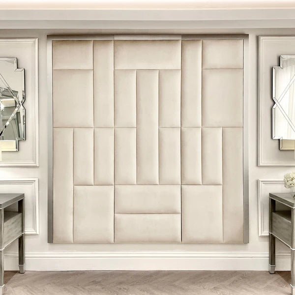 Cream and silver abstract upholstered headboard with geometric panels in a luxury bedroom setting