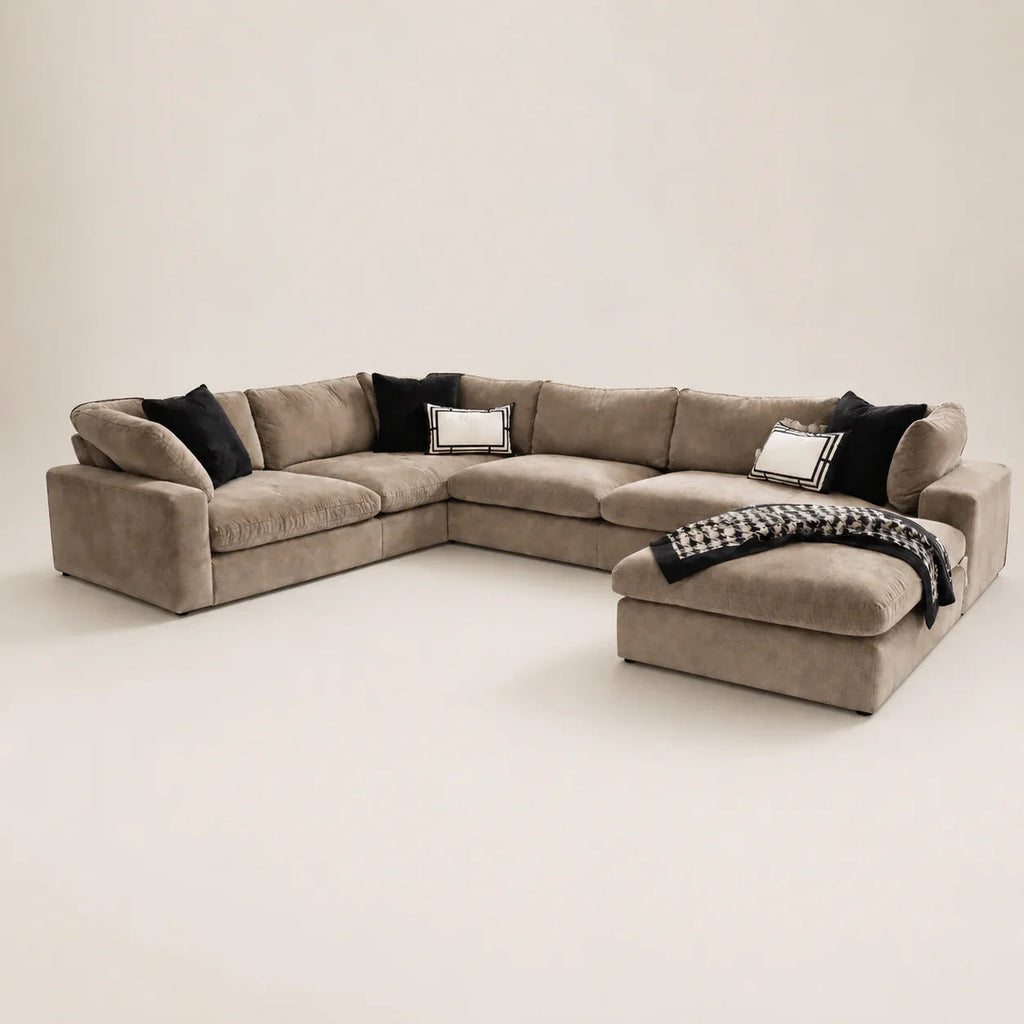 Luxury beige sectional sofa with black and white pillows, perfect for modern living rooms