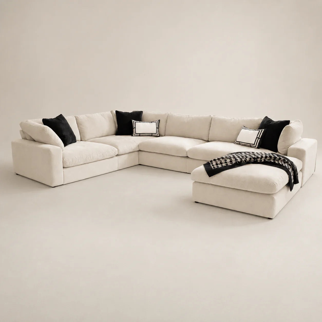 Luxury cream sectional sofa with black pillows and houndstooth throw, modern living room furniture