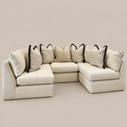 Cream modular sectional sofa with black-trimmed pillows, luxury living room furniture