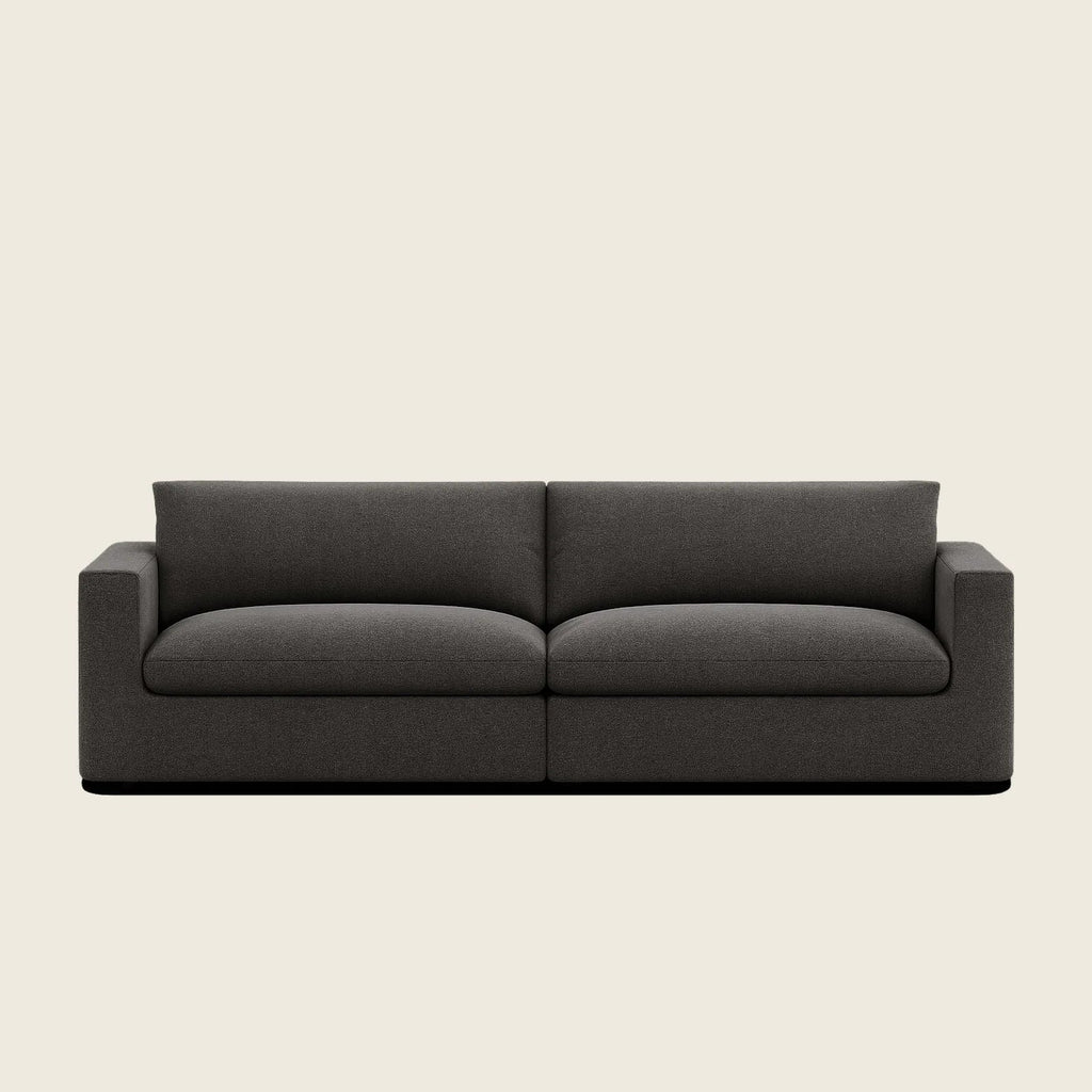 Modern dark grey fabric sofa with clean lines and plush cushions, ideal for luxury living rooms