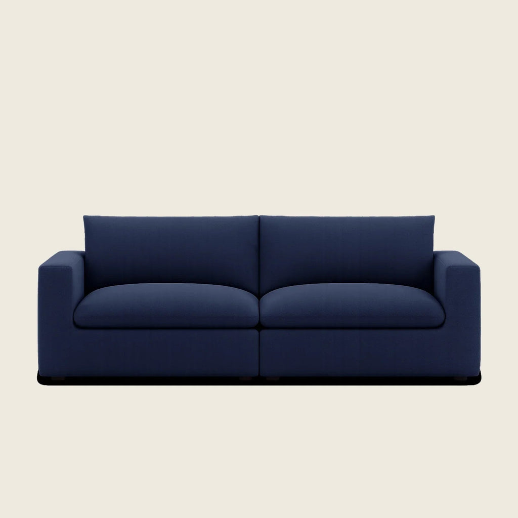 Navy blue modern two-seater sofa with clean lines and plush cushions, ideal for luxury living rooms.