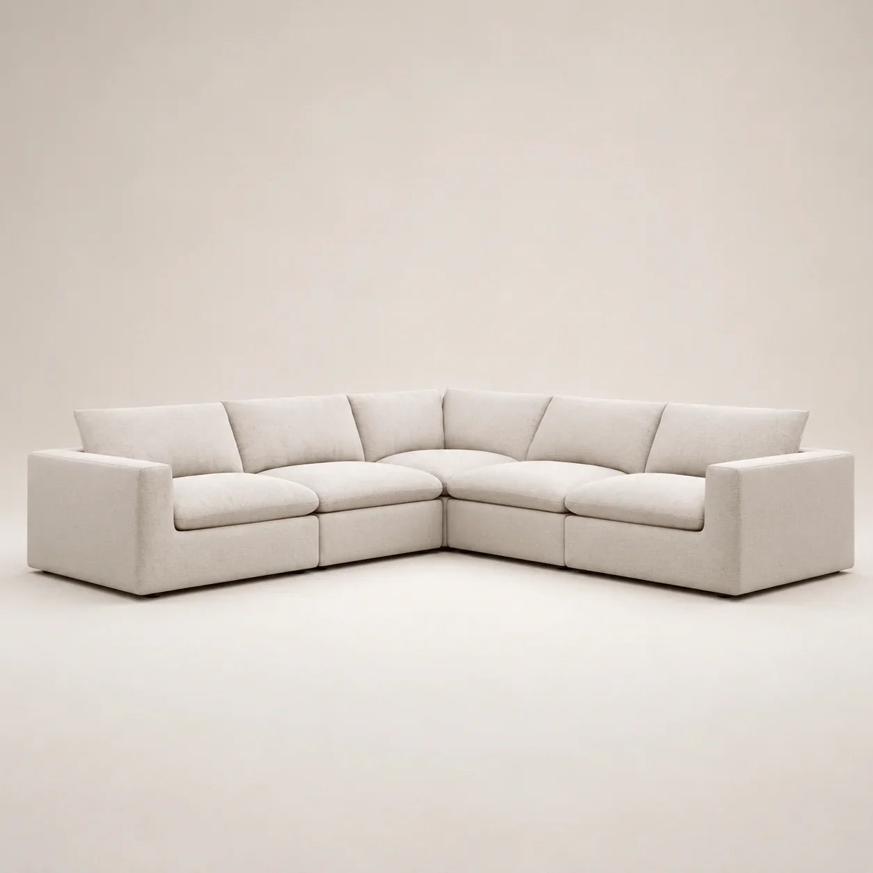 Modern beige sectional sofa with plush cushions, ideal for luxury living rooms