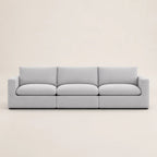 Modern light gray three-seater sofa with clean lines and plush cushions, ideal for luxury living rooms