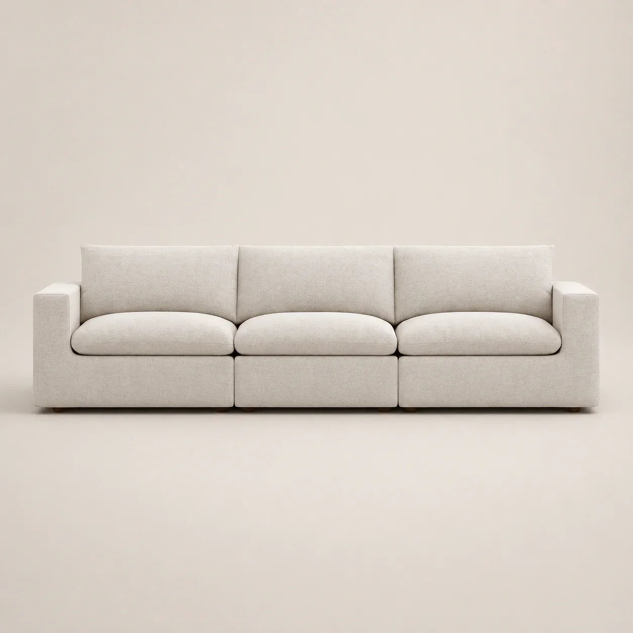 Modern beige 3-seater sofa with clean lines and plush cushions, ideal for luxury living rooms