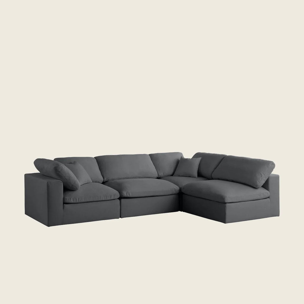 Dark gray L-shaped sectional sofa with plush cushions, ideal for modern living rooms