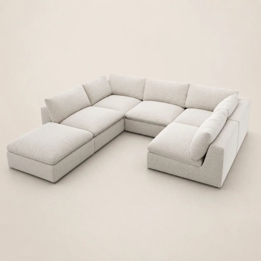 Modern L-shaped sectional sofa with chaise lounges in light neutral fabric, perfect for luxury living rooms