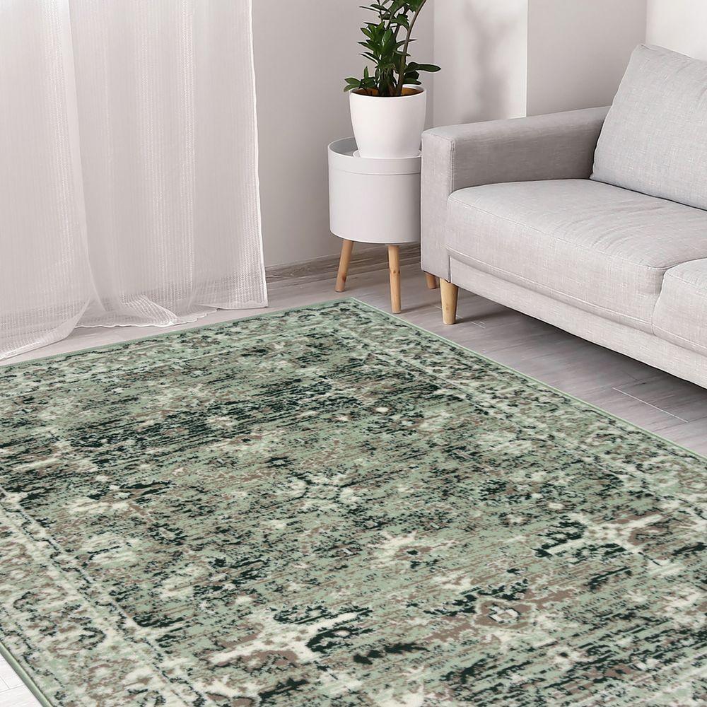 Vintage-style green area rug with distressed pattern in modern living room