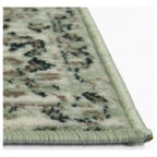 Green patterned area rug with braided edge, ideal for living room or bedroom decor