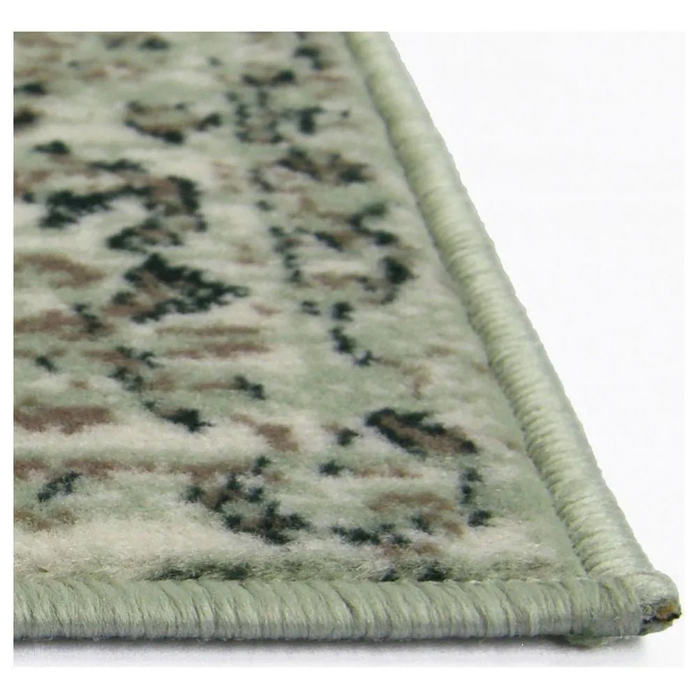 Green patterned area rug with braided edge, ideal for living room or bedroom decor