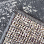 Grey abstract patterned rug with textured weave and fringed edge, ideal for modern living spaces