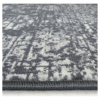 Grey and white distressed pattern area rug with plush texture and bound edge